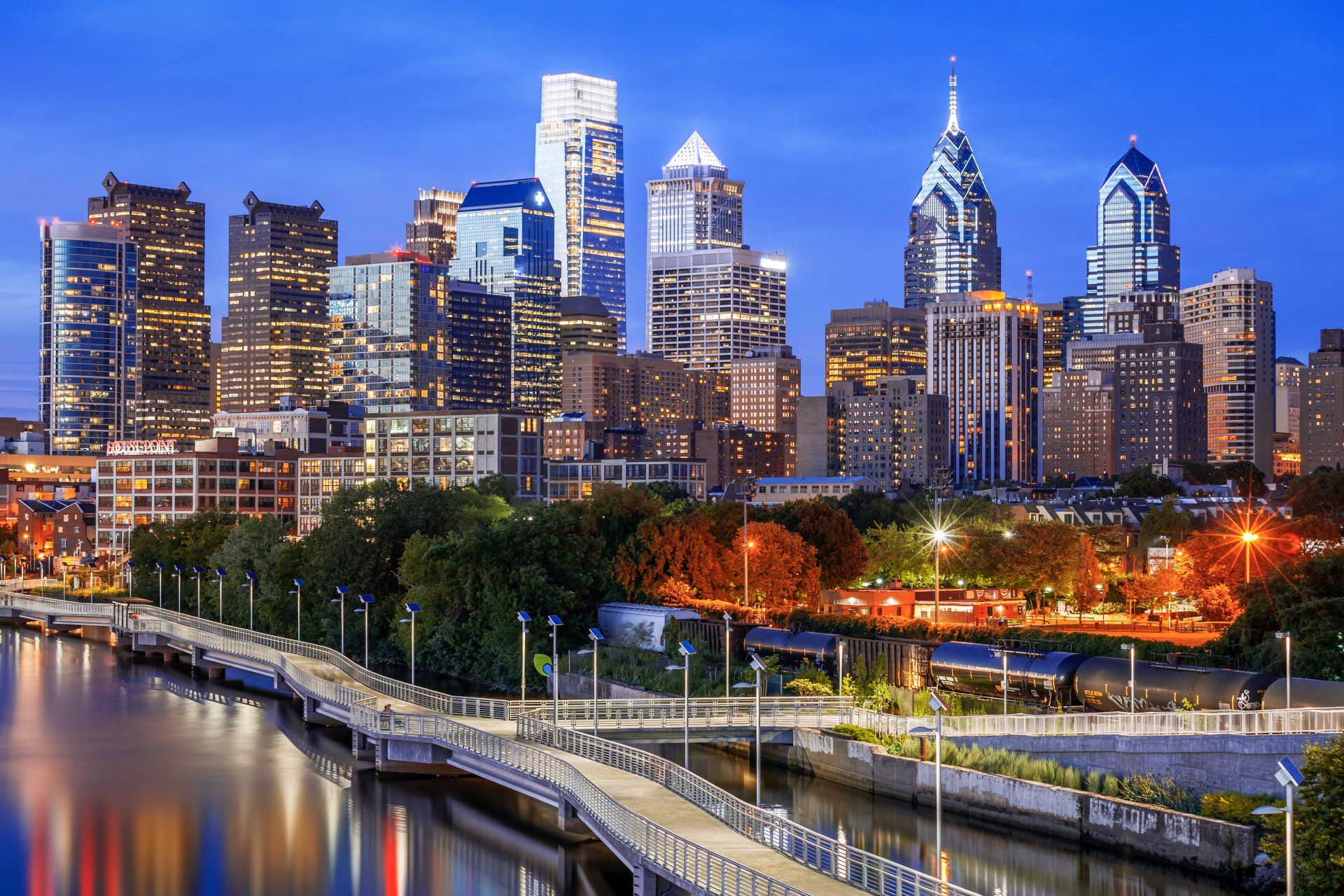 A city skyline with a bridge in the foreground and a river in the background