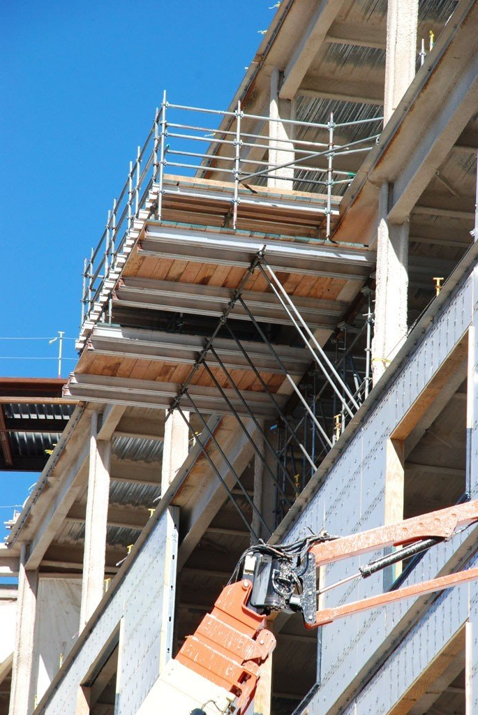 A large building under construction with scaffolding on the side of it.