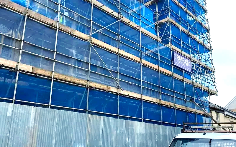A large building with scaffolding on the side of it.