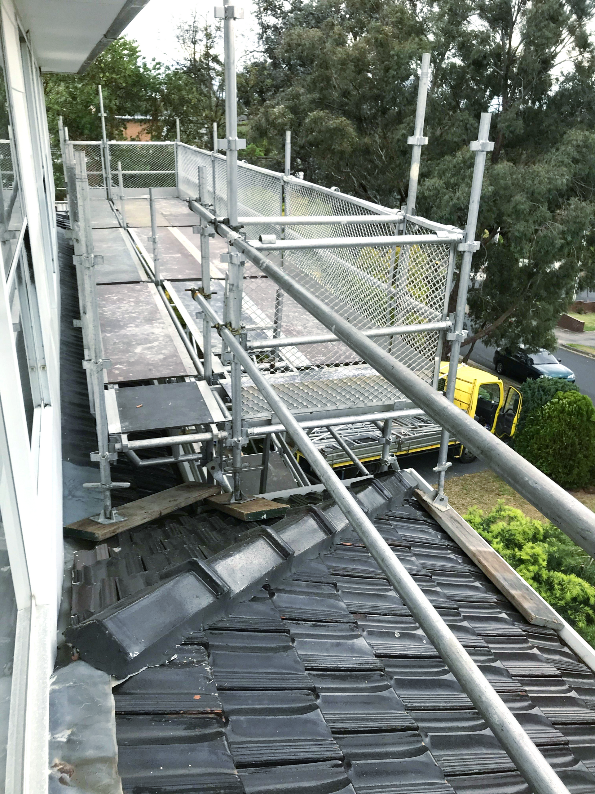 A scaffolding is being built on the side of a building.