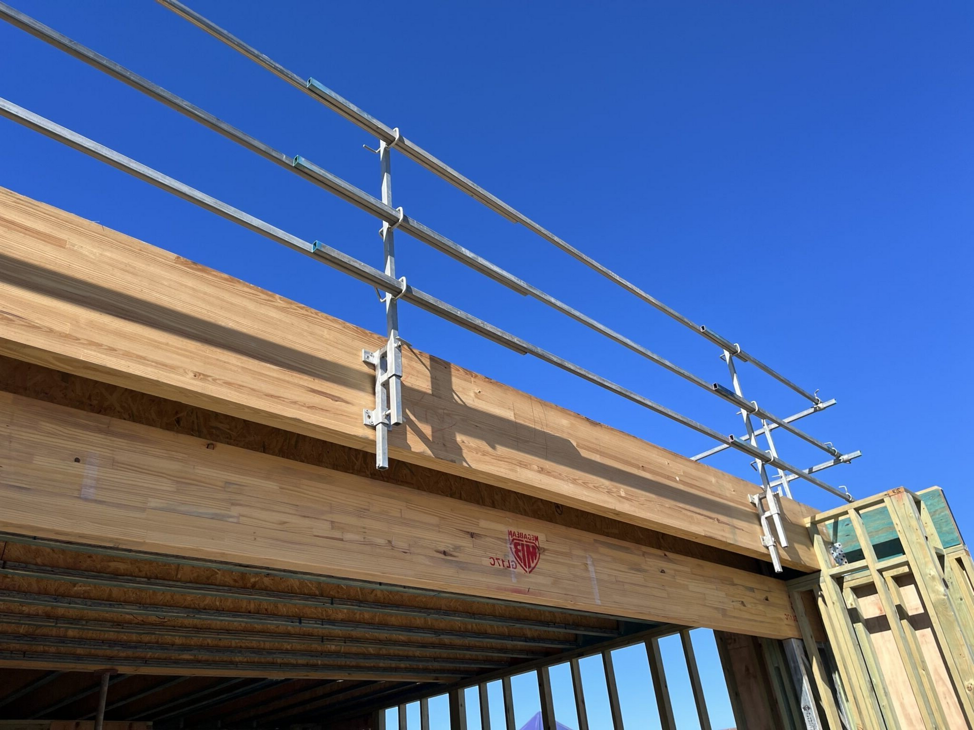 A metal railing is attached to a wooden structure.