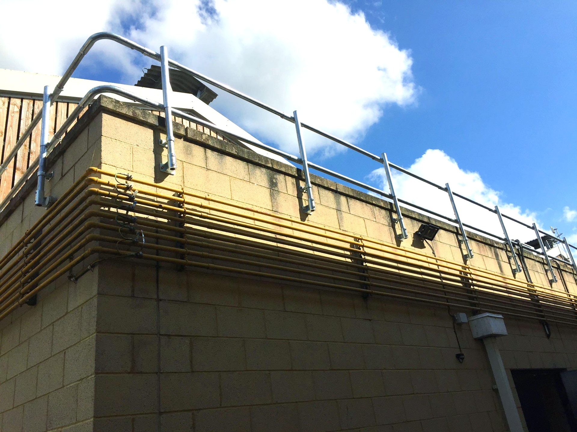 A brick building with a metal railing on the side of it.