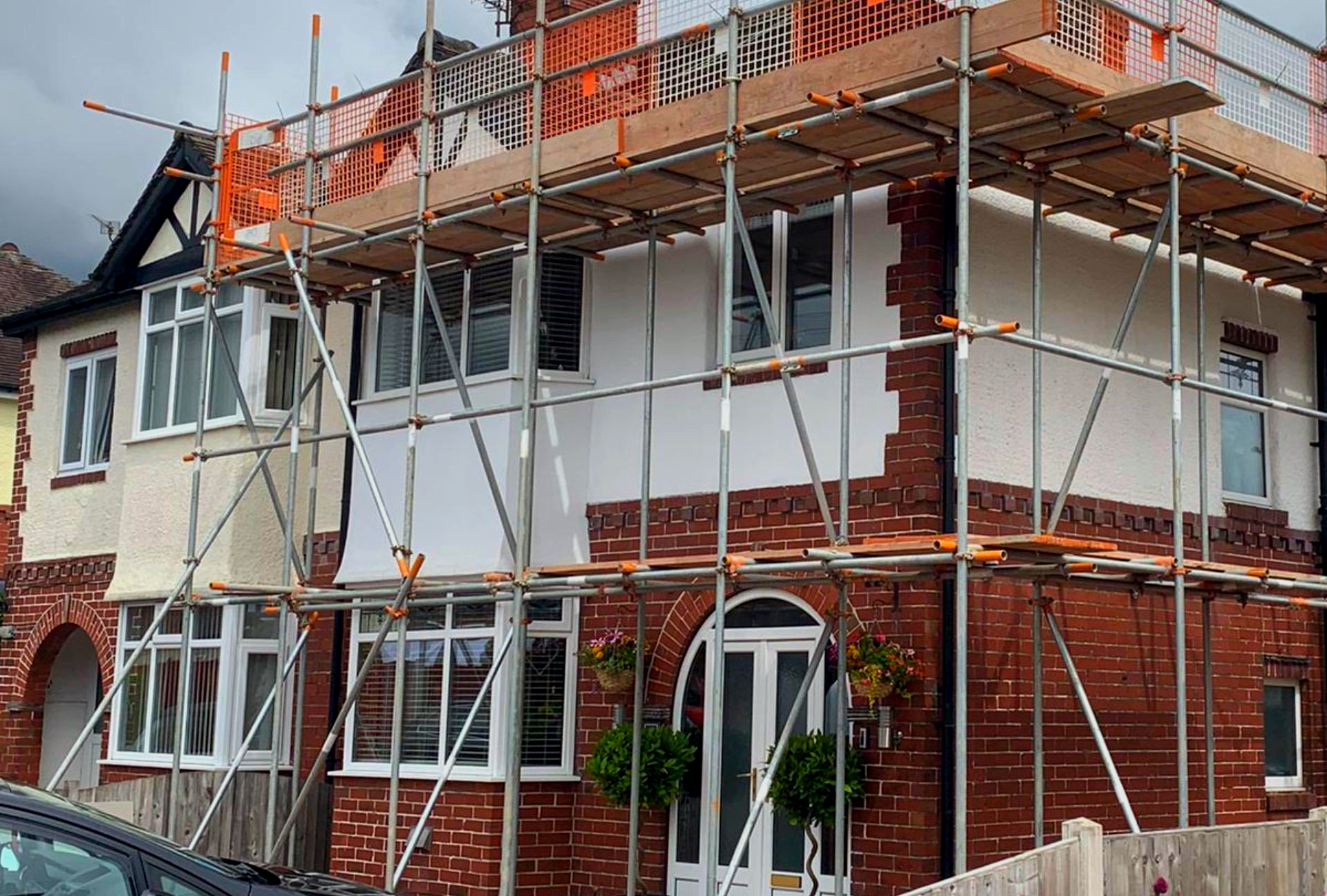 A brick house is being remodeled with scaffolding around it.