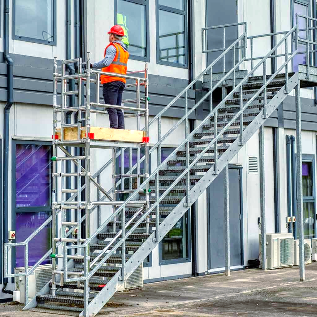 A man is standing on top of a set of stairs.