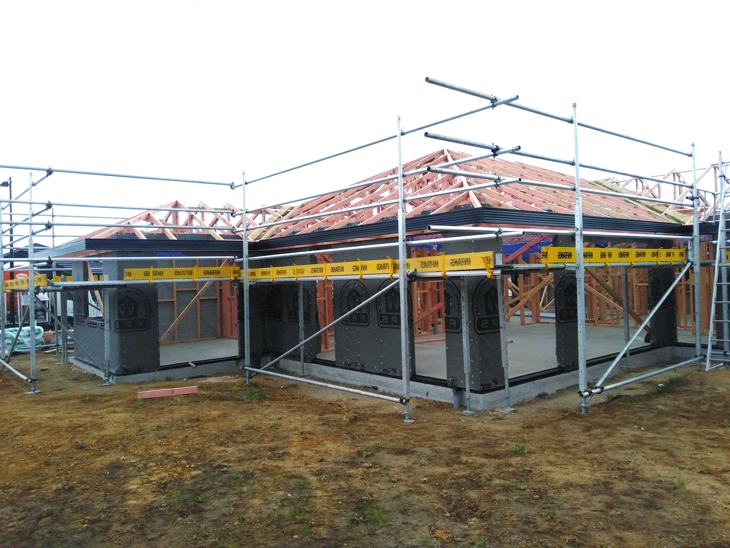 A house is being built with scaffolding around it.