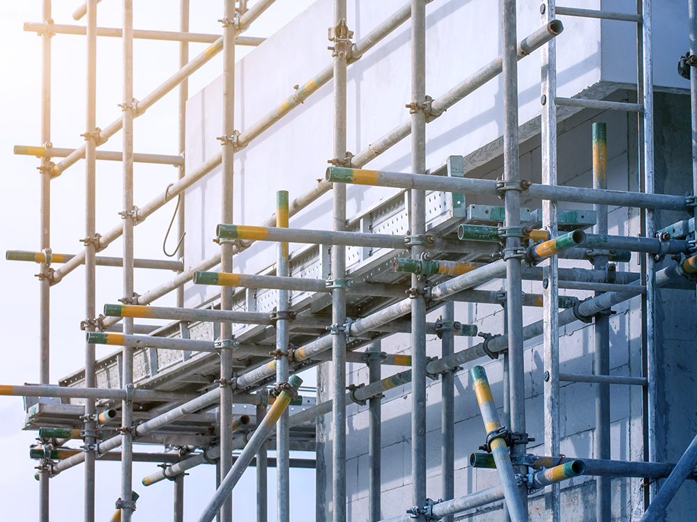 A building is being built with tube and clip scaffolding around it.