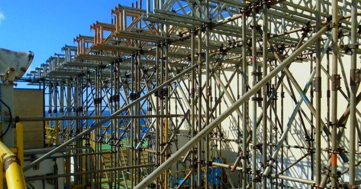 A row of scaffolding is sitting in front of a building under construction.