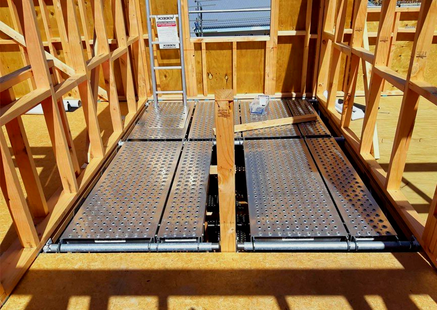 A metal scaffolding is being used to build a house.