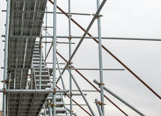 a row of scaffolding with stairs on a cloudy day