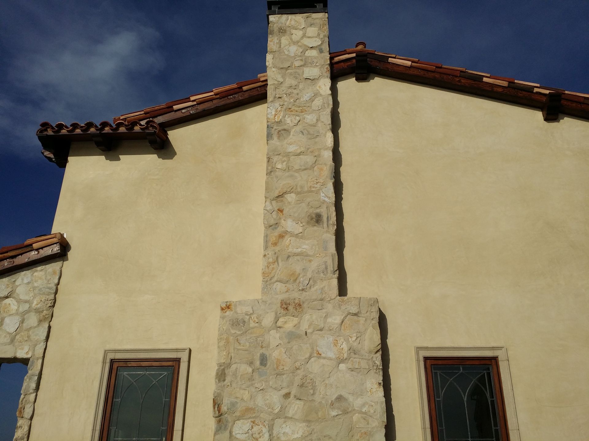 A stone chimney on the side of a building