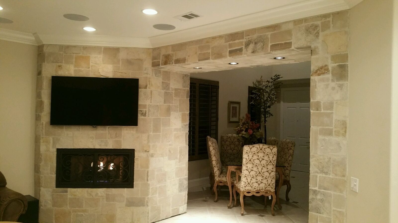 A living room with a fireplace and a flat screen tv.