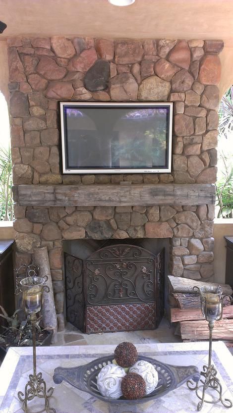 A fireplace with a flat screen tv mounted above it.
