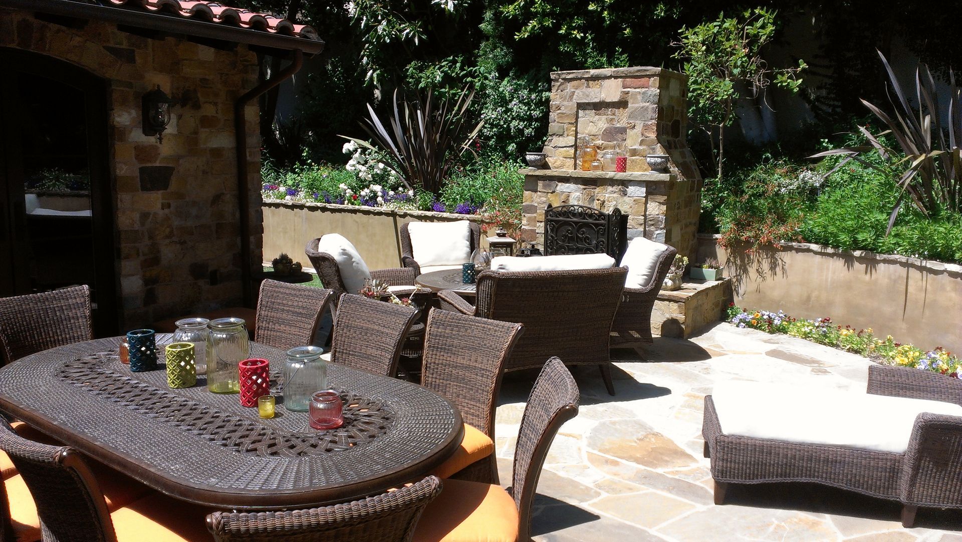 A patio with a table and chairs and a fireplace