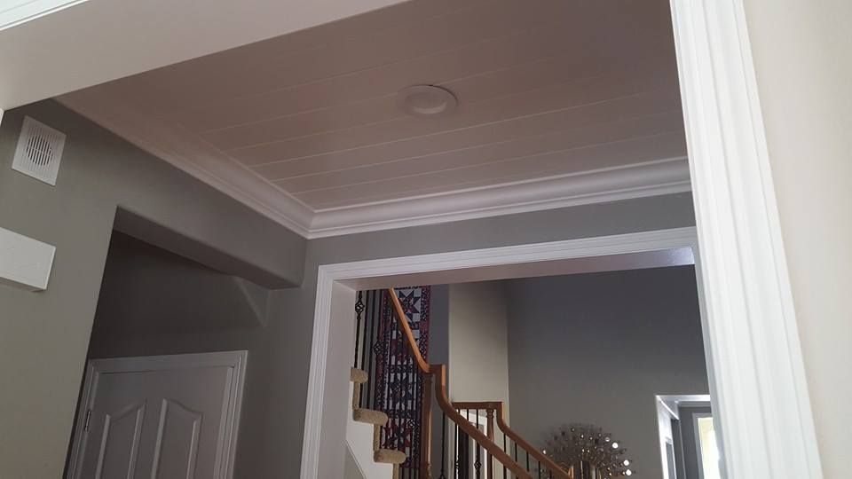 Interior entryway with white trim, gray walls, and a staircase.