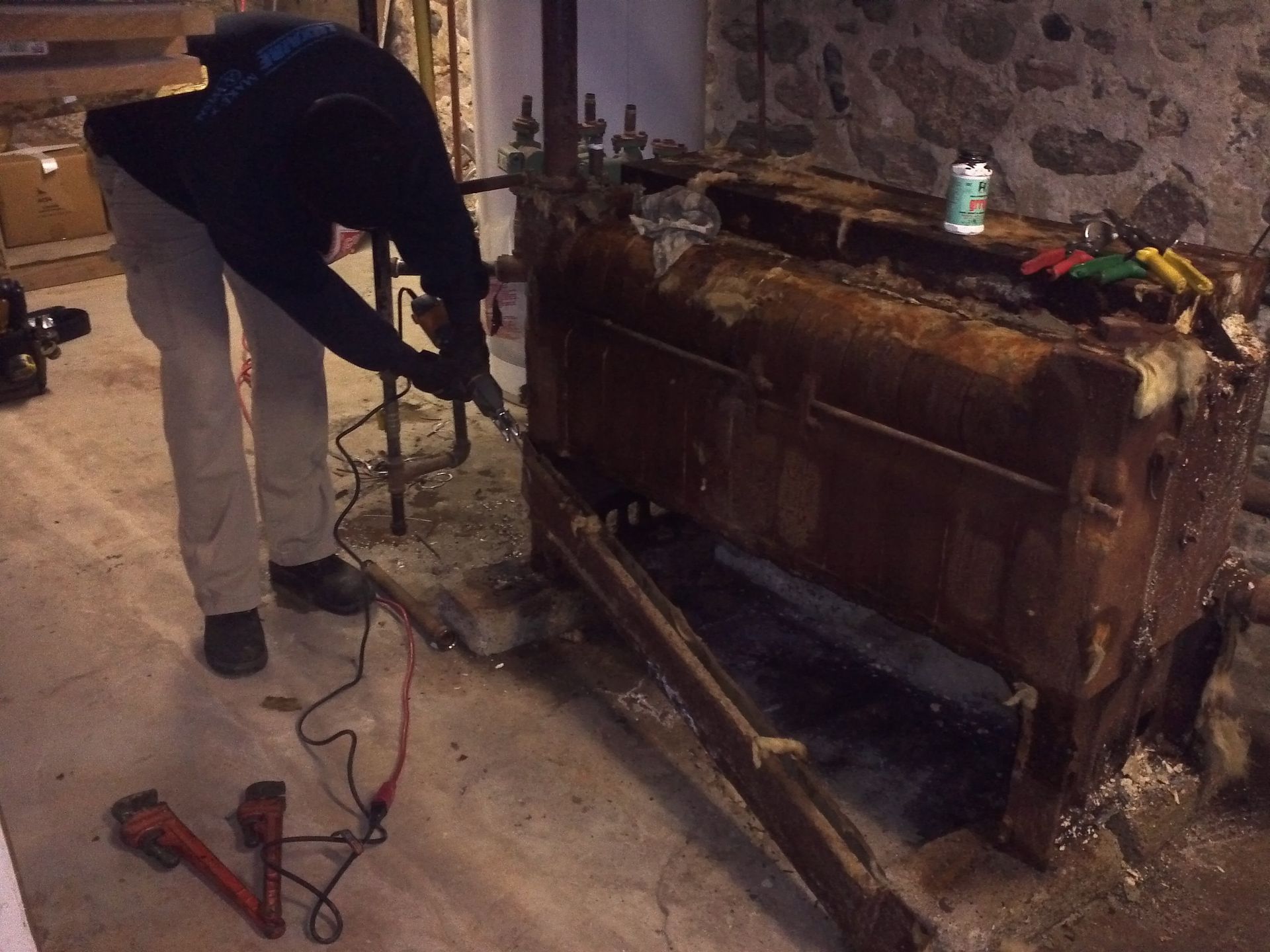 A man is working on a machine in a room