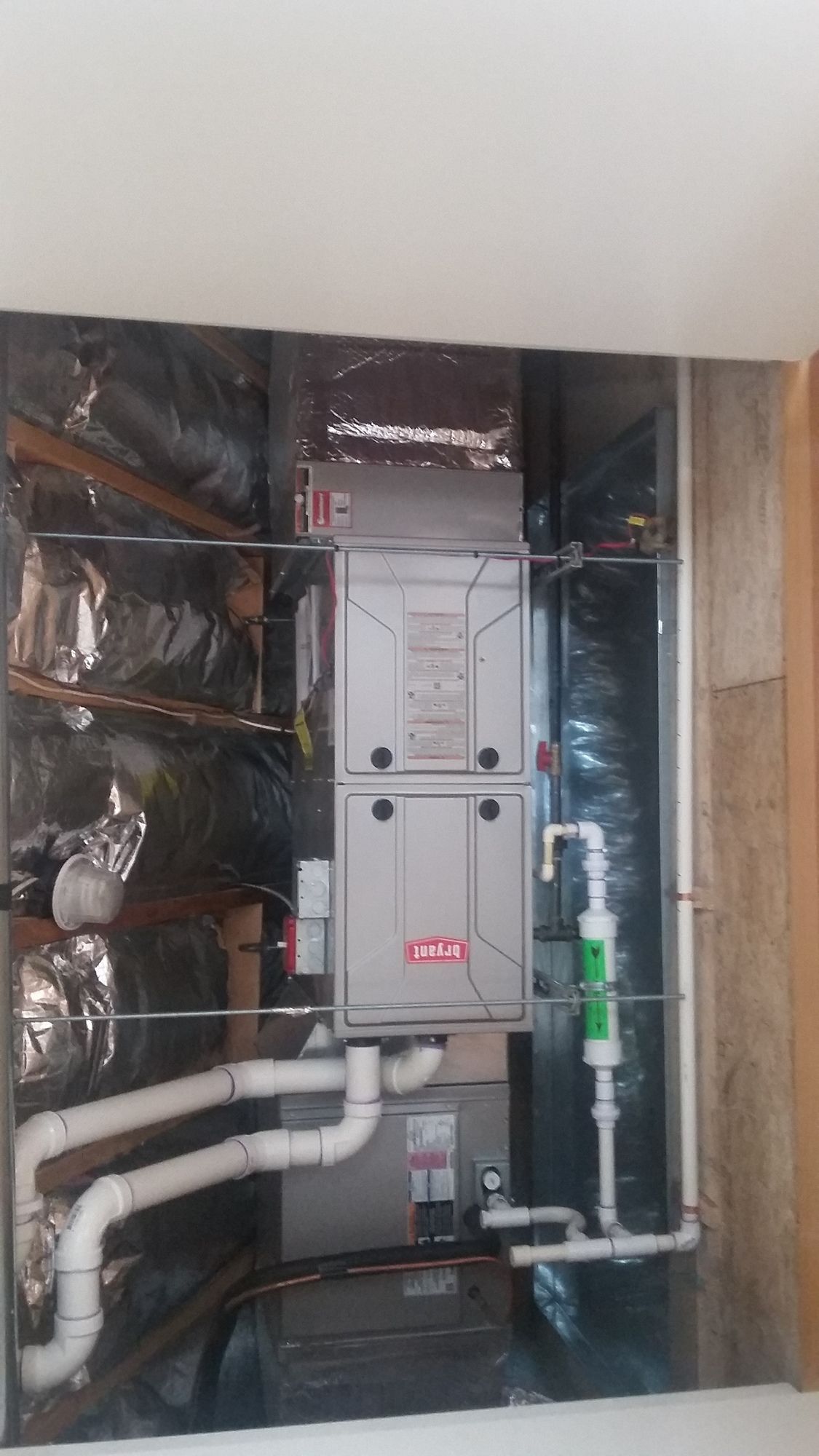 A picture of a heating and cooling system in a basement.