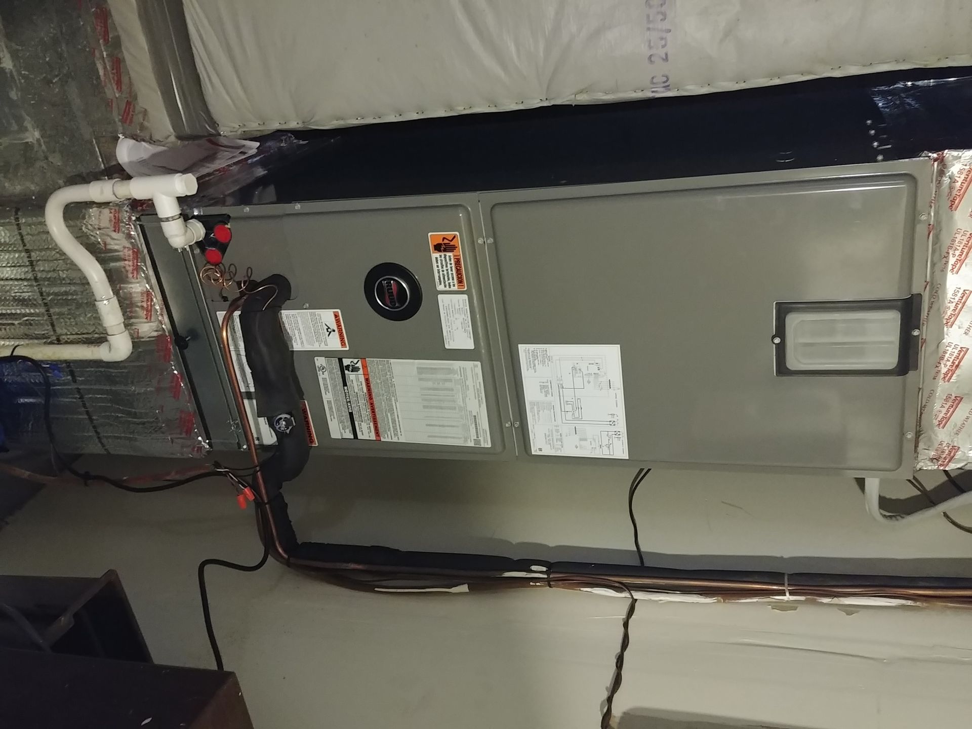 An air conditioner is hanging from the ceiling in a room.