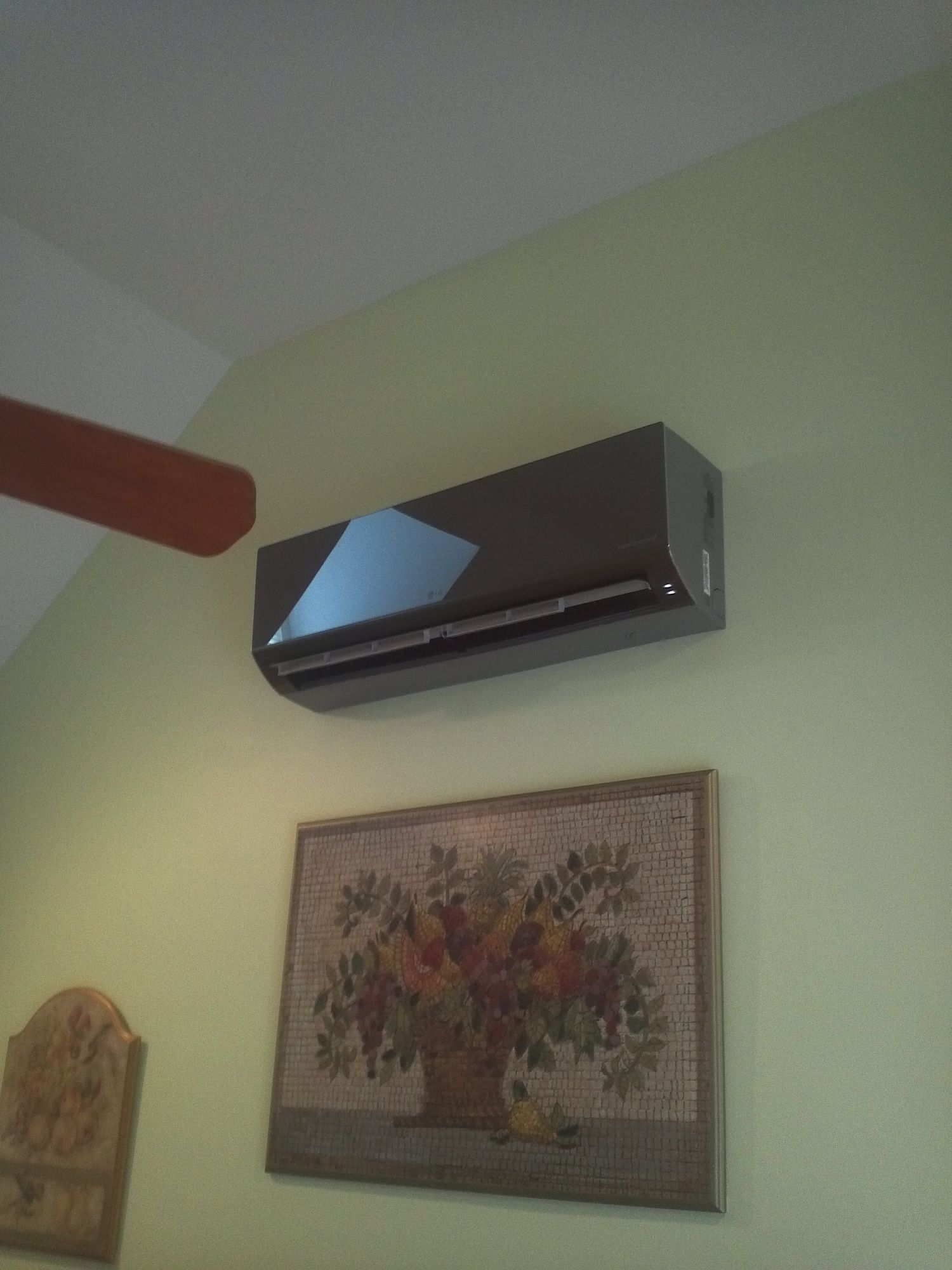 A room with a ceiling fan and a picture on the wall