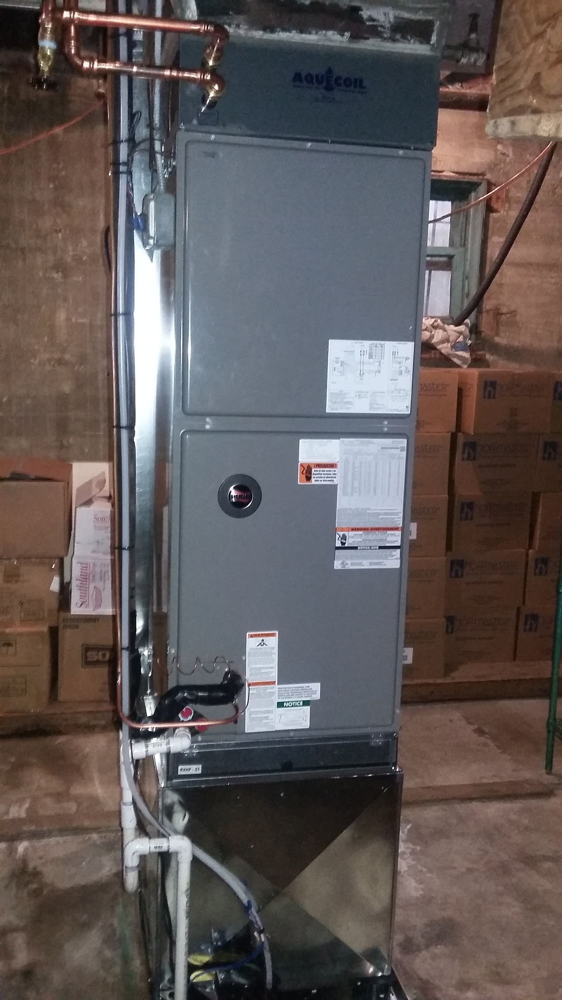 A heating and cooling system is installed in a basement.