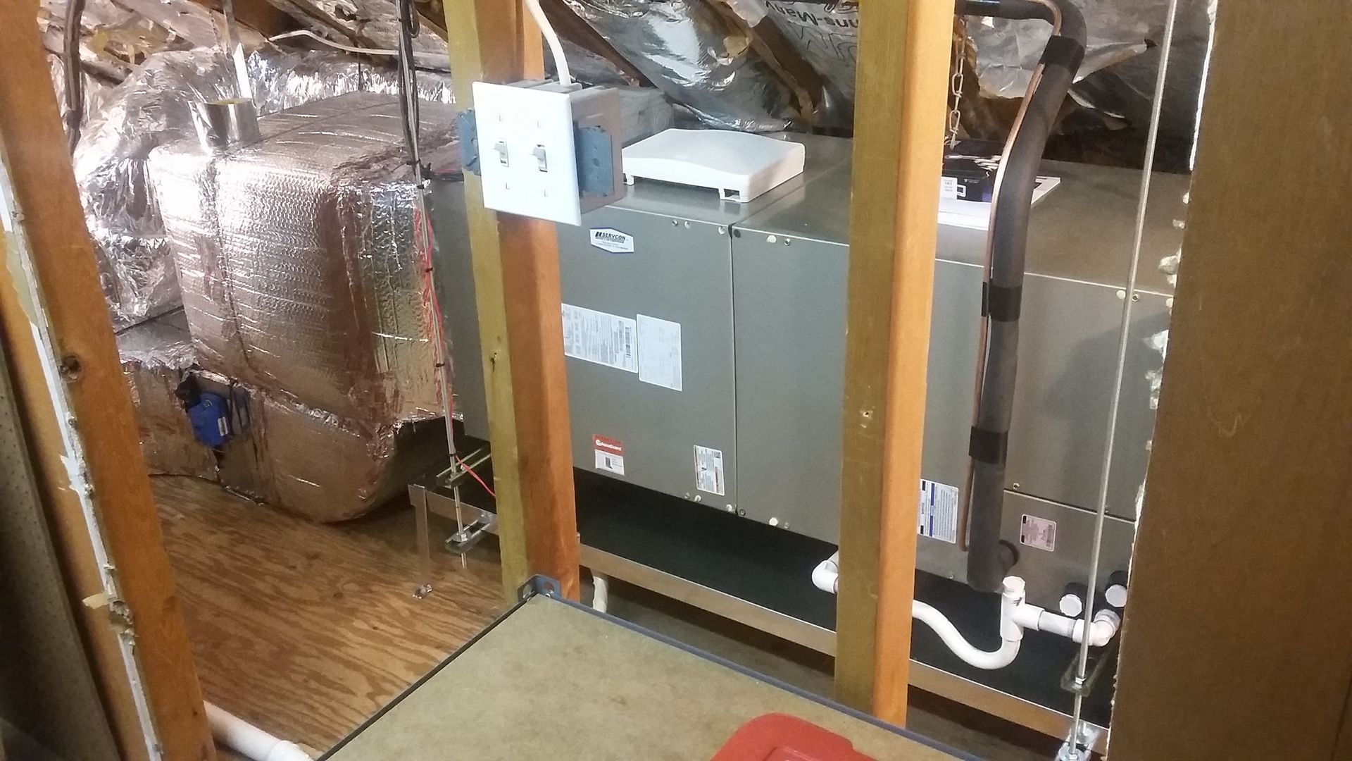 A room with a furnace and a heater in it.