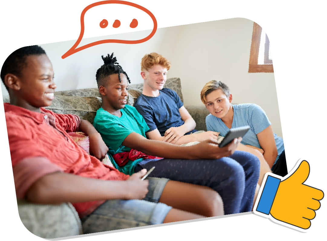 A group of teen boys are sitting on a couch looking at a tablet device.