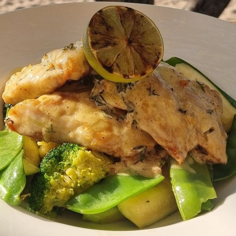 Grilled Fish With Vegetables and a Lime Wedge — The Beach Bar and Restaurant at Montes in Cape Gloucester, QLD