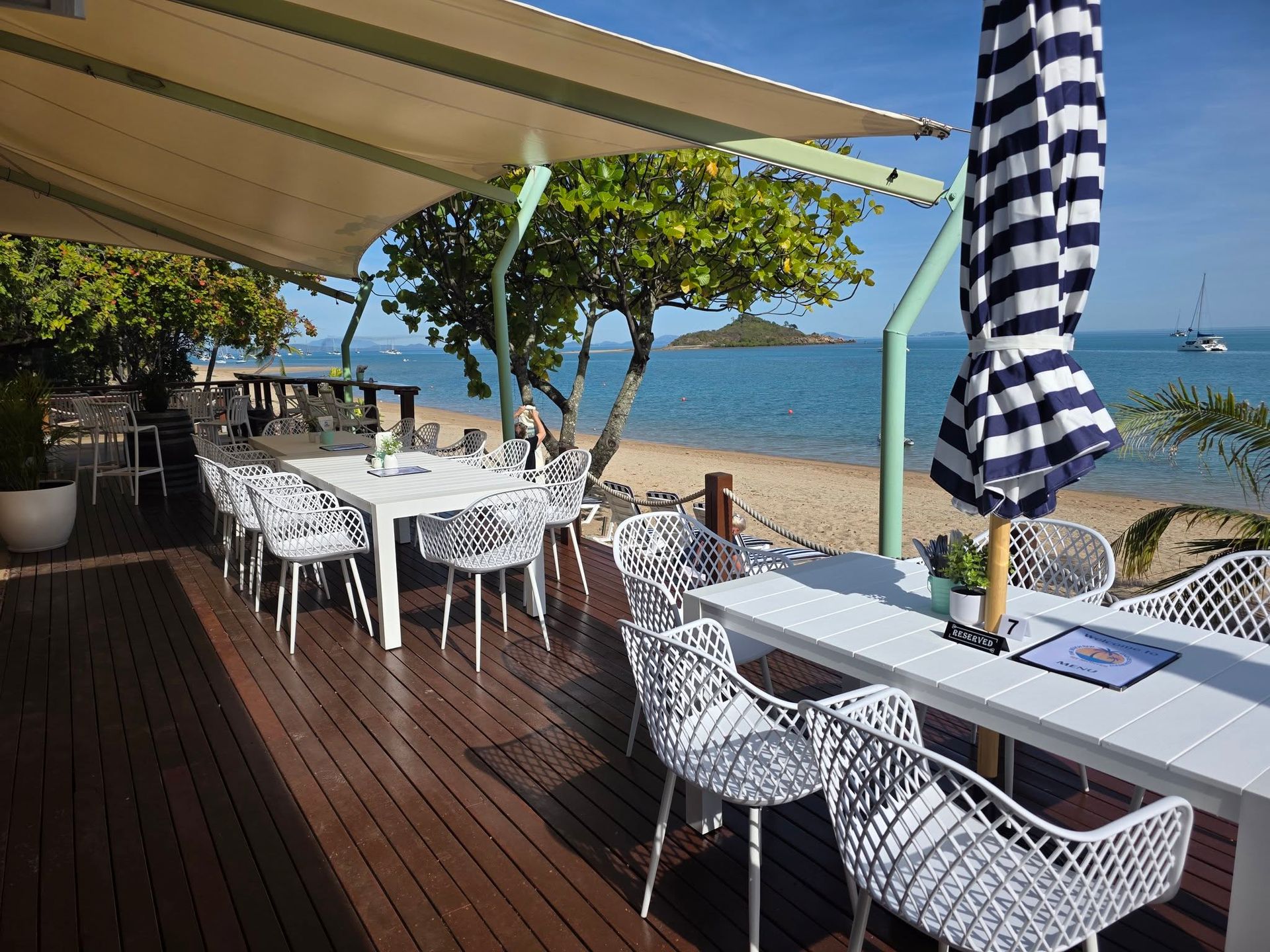 Outdoor Beachside Restaurant With White Tables — The Beach Bar and Restaurant at Montes in Cape Gloucester, QLD