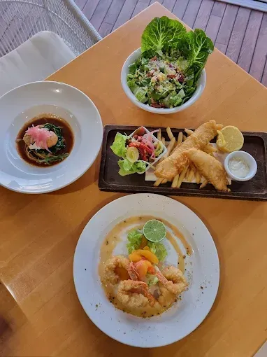 Four plates of food on a table — The Beach Bar and Restaurant at Montes in Cape Gloucester, QLD