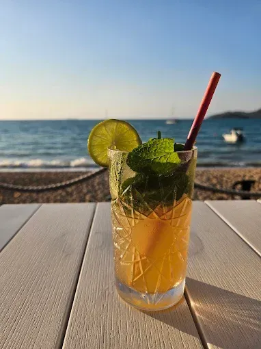 Cocktail on a white table at the beach — The Beach Bar and Restaurant at Montes in Cape Gloucester, QLD