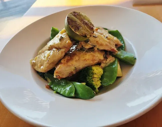 Grilled chicken and vegetables in white bowl — The Beach Bar and Restaurant at Montes in Cape Gloucester, QLD