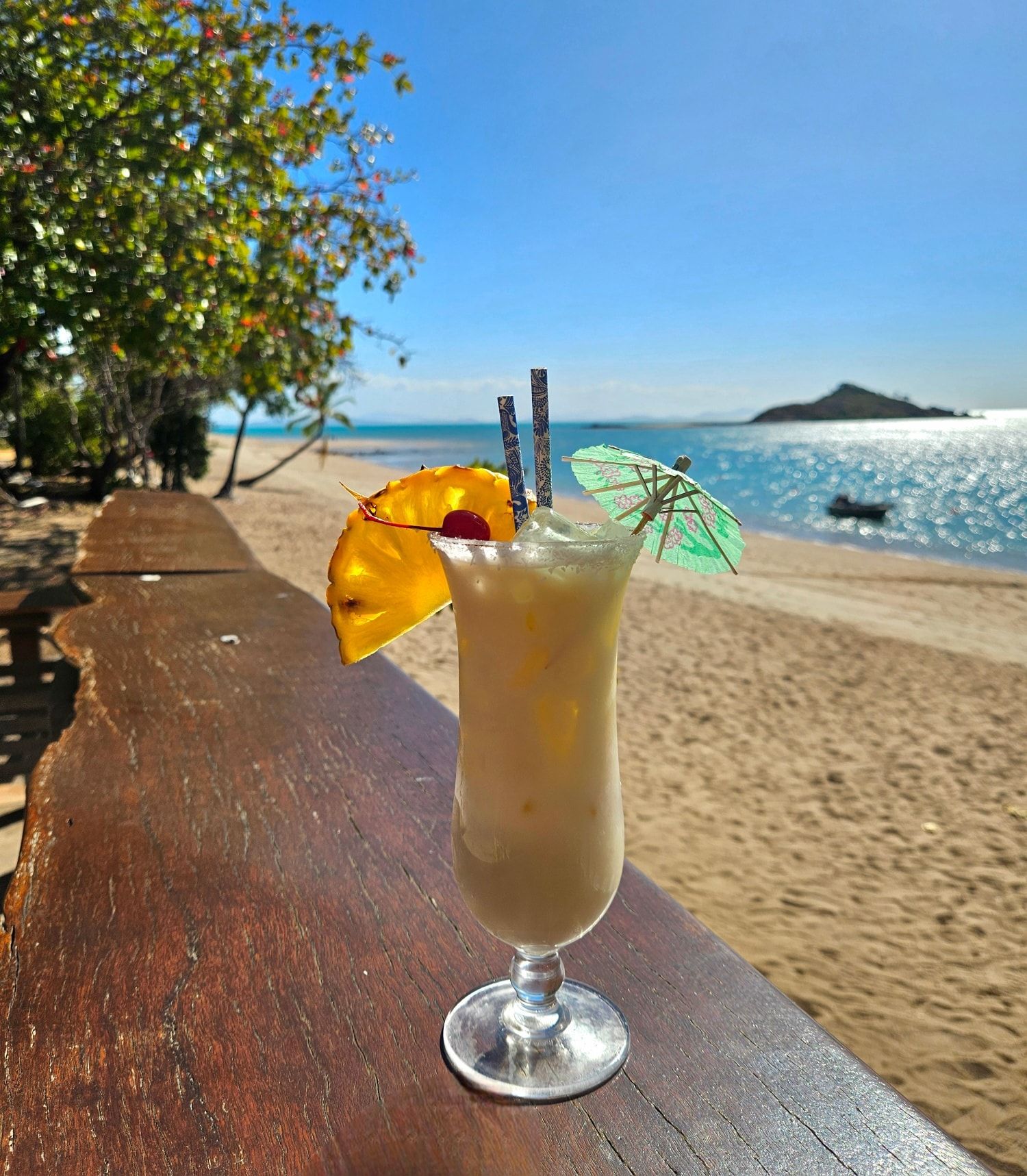 Pina Colada Cocktail on a Wooden Surface — The Beach Bar and Restaurant at Montes in Cape Gloucester, QLD