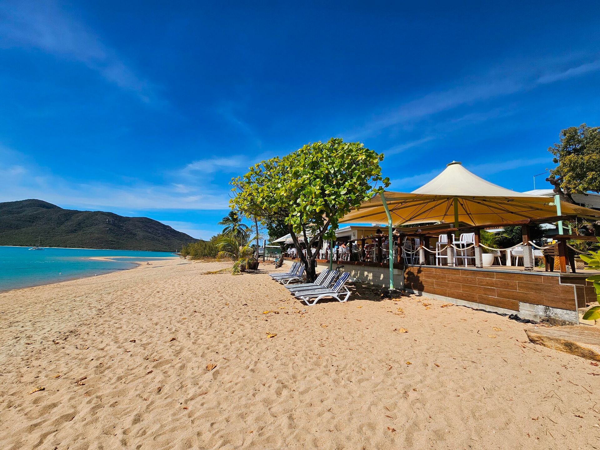 Beachside Restaurant With Umbrella — The Beach Bar and Restaurant at Montes in Cape Gloucester, QLD