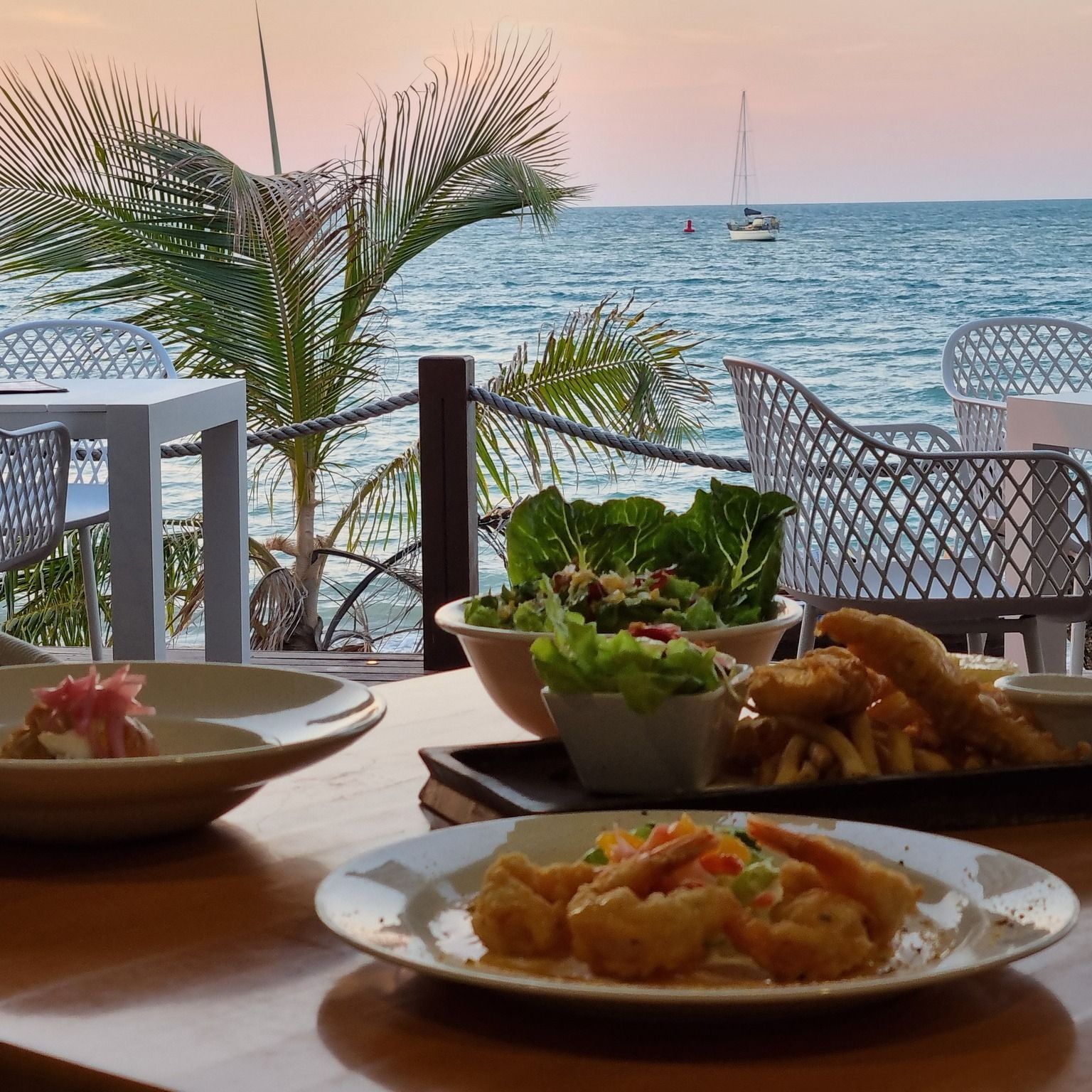 Seafood meal at a beachfront restaurant — The Beach Bar and Restaurant at Montes in Cape Gloucester, QLD