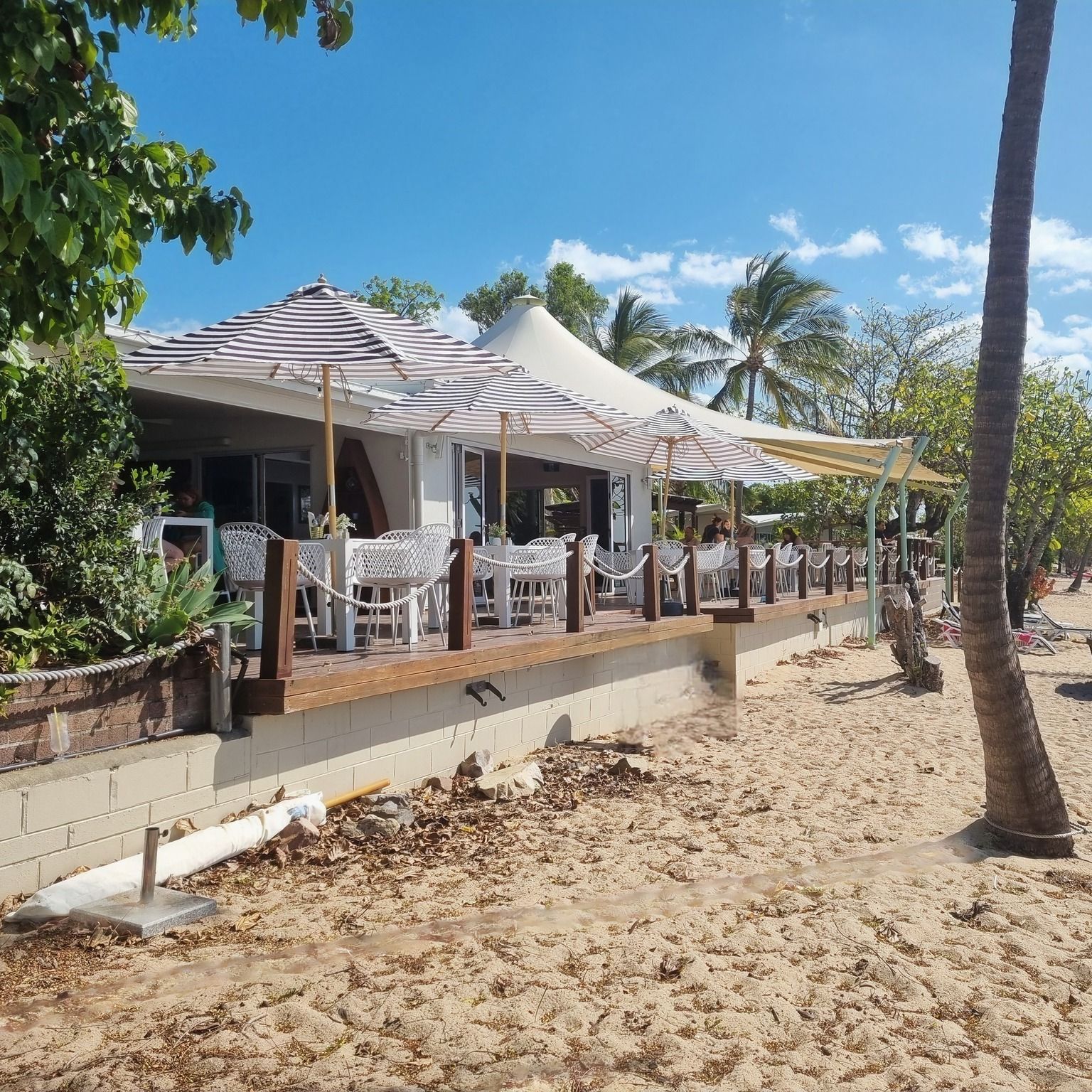 Restaurant with outdoor seating on a beach — The Beach Bar and Restaurant at Montes in Cape Gloucester, QLD