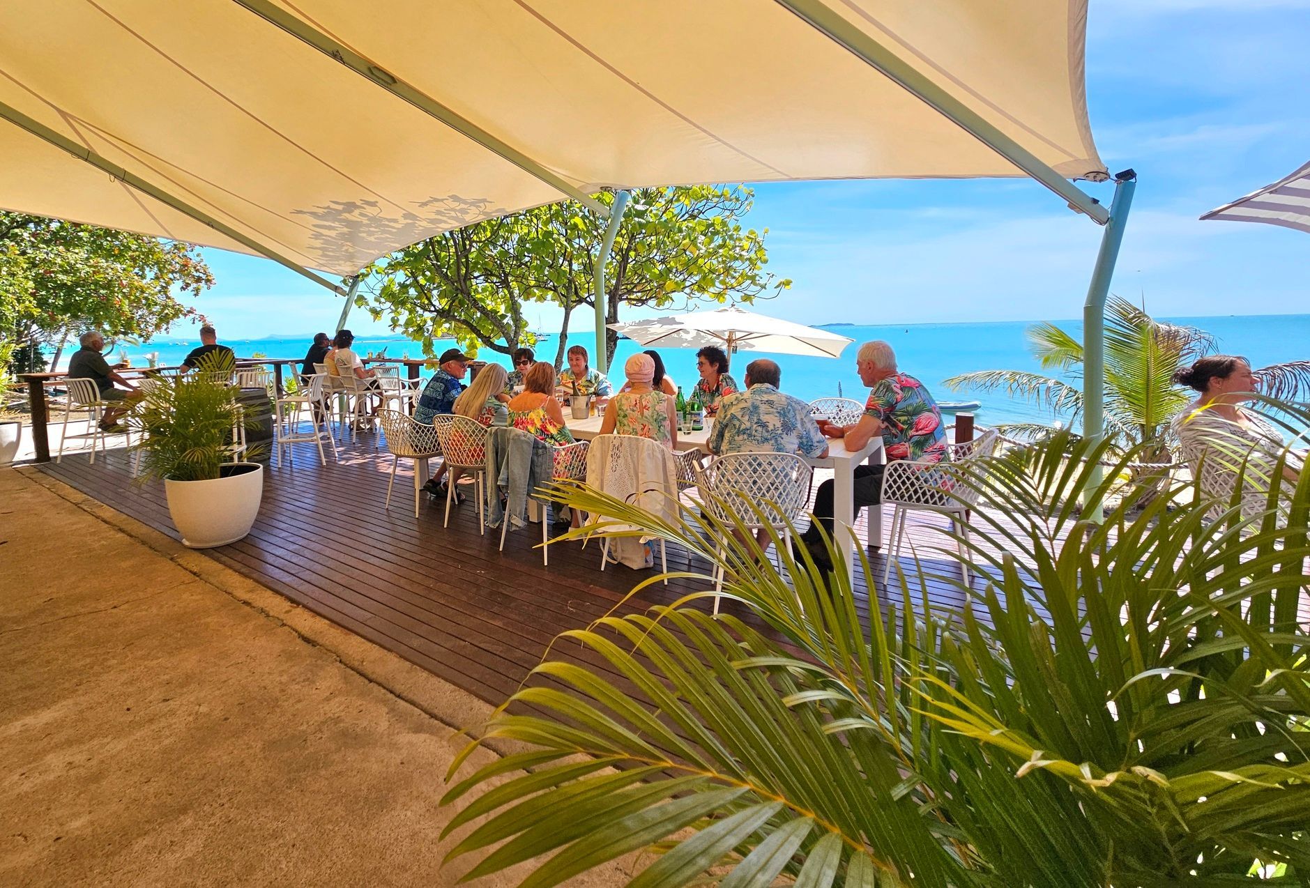 People Dining Outdoors on a Beachfront Patio — The Beach Bar and Restaurant at Montes in Cape Gloucester, QLD