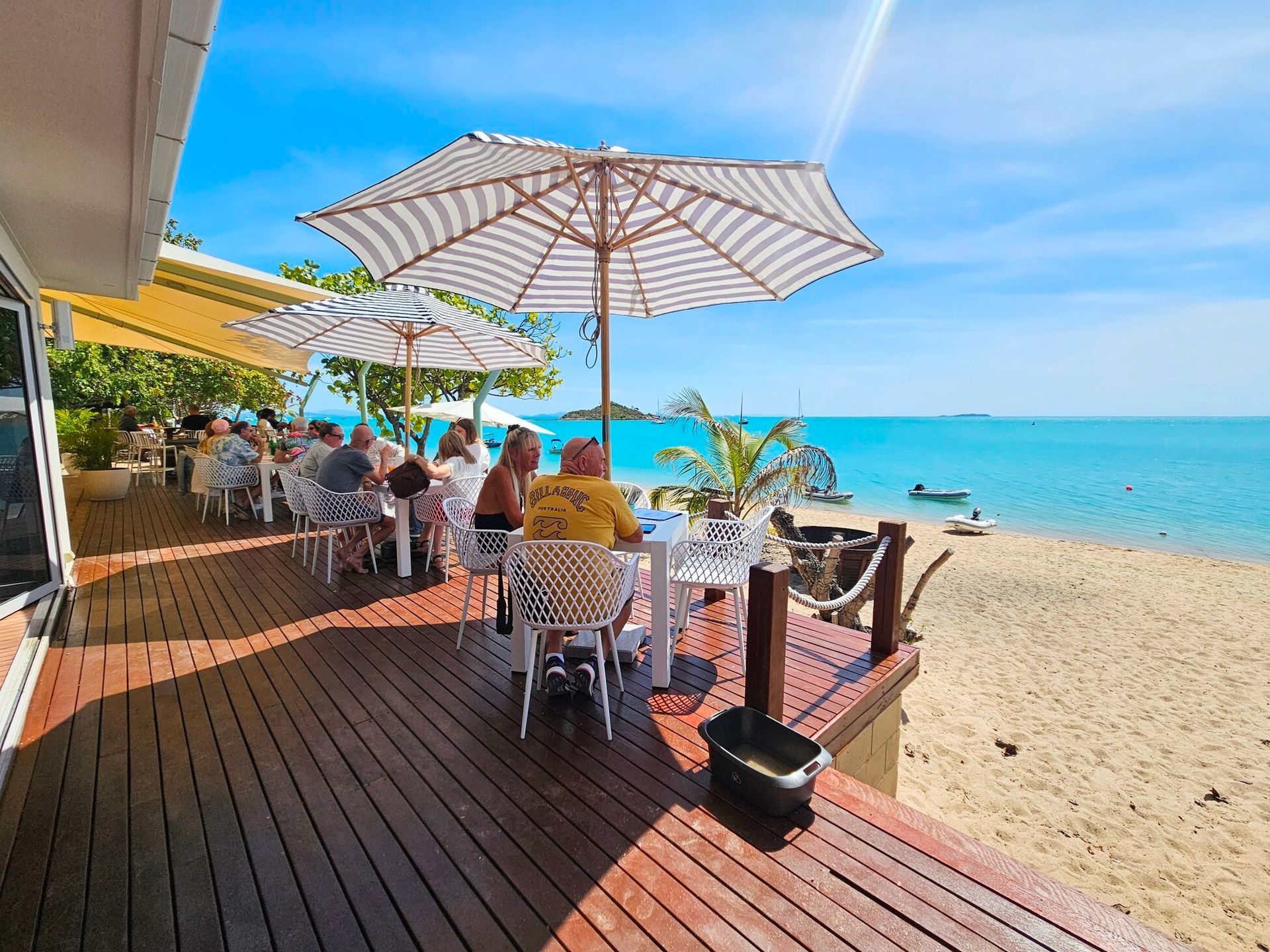 Beachside Cafe With People Dining — The Beach Bar and Restaurant at Montes in Cape Gloucester, QLD