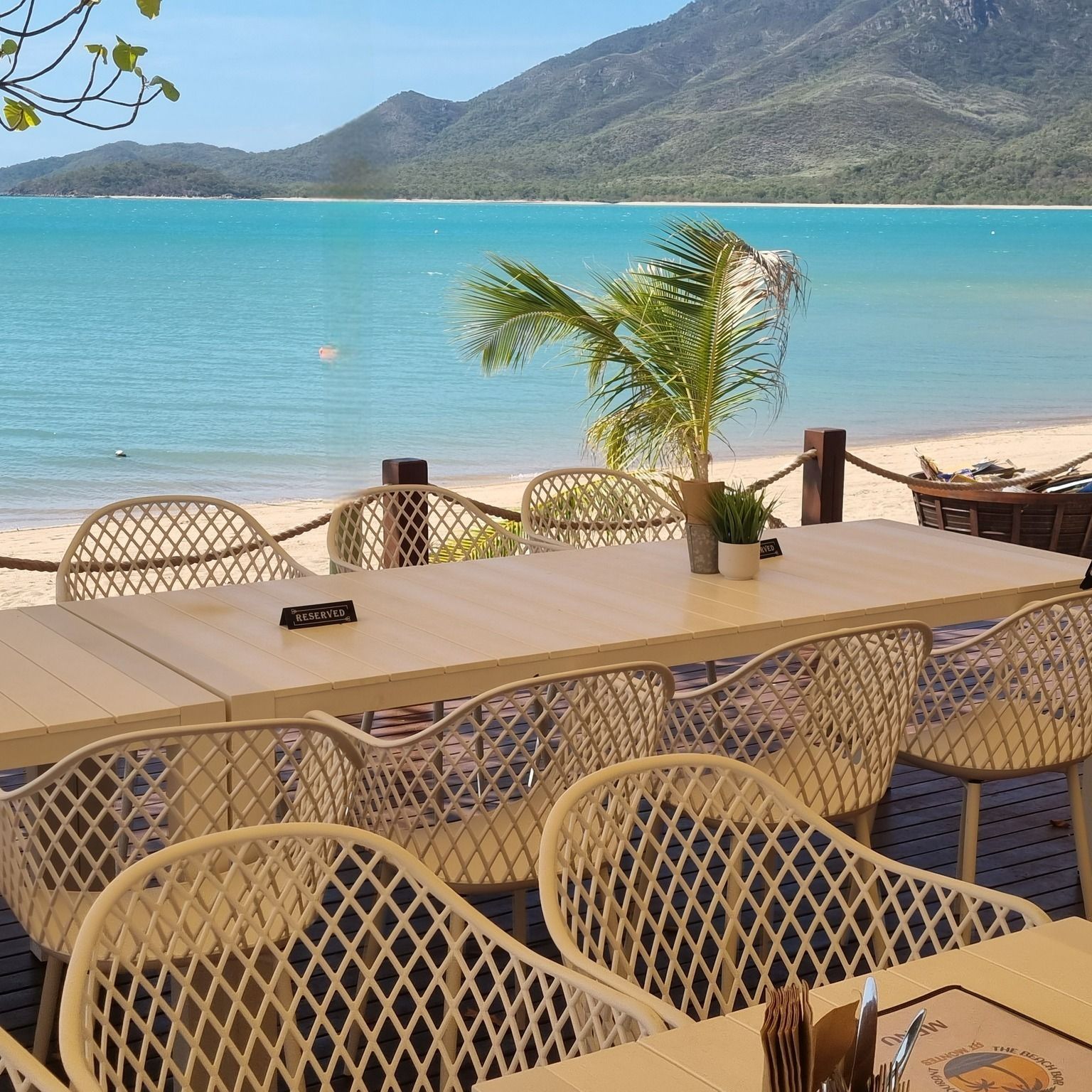 Beachside Restaurant With Tables and Chairs — The Beach Bar and Restaurant at Montes in Cape Gloucester, QLD