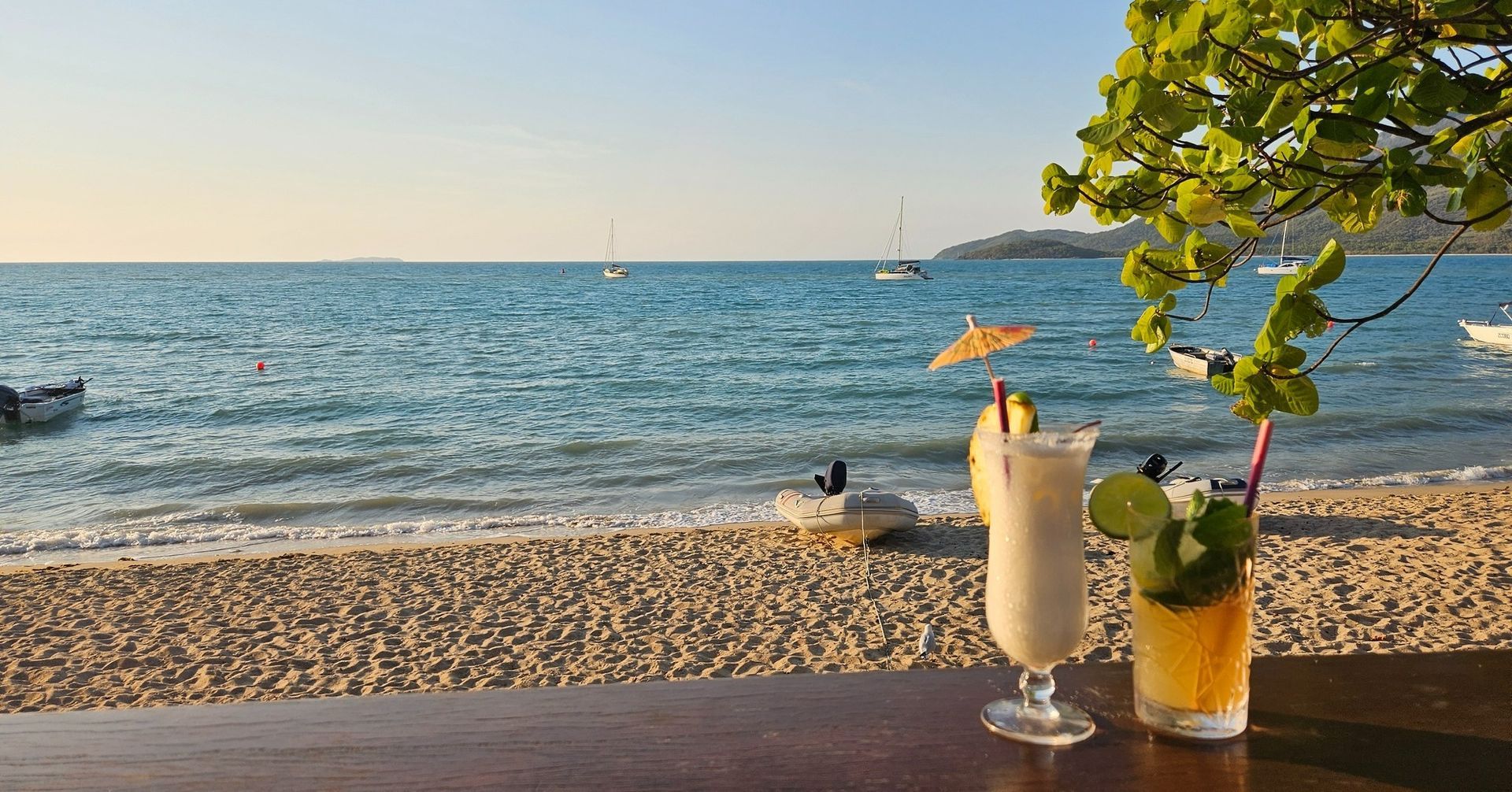 Two Cocktails on a Table Overlooking a Beach — The Beach Bar and Restaurant at Montes in Airlie Beach, QLD