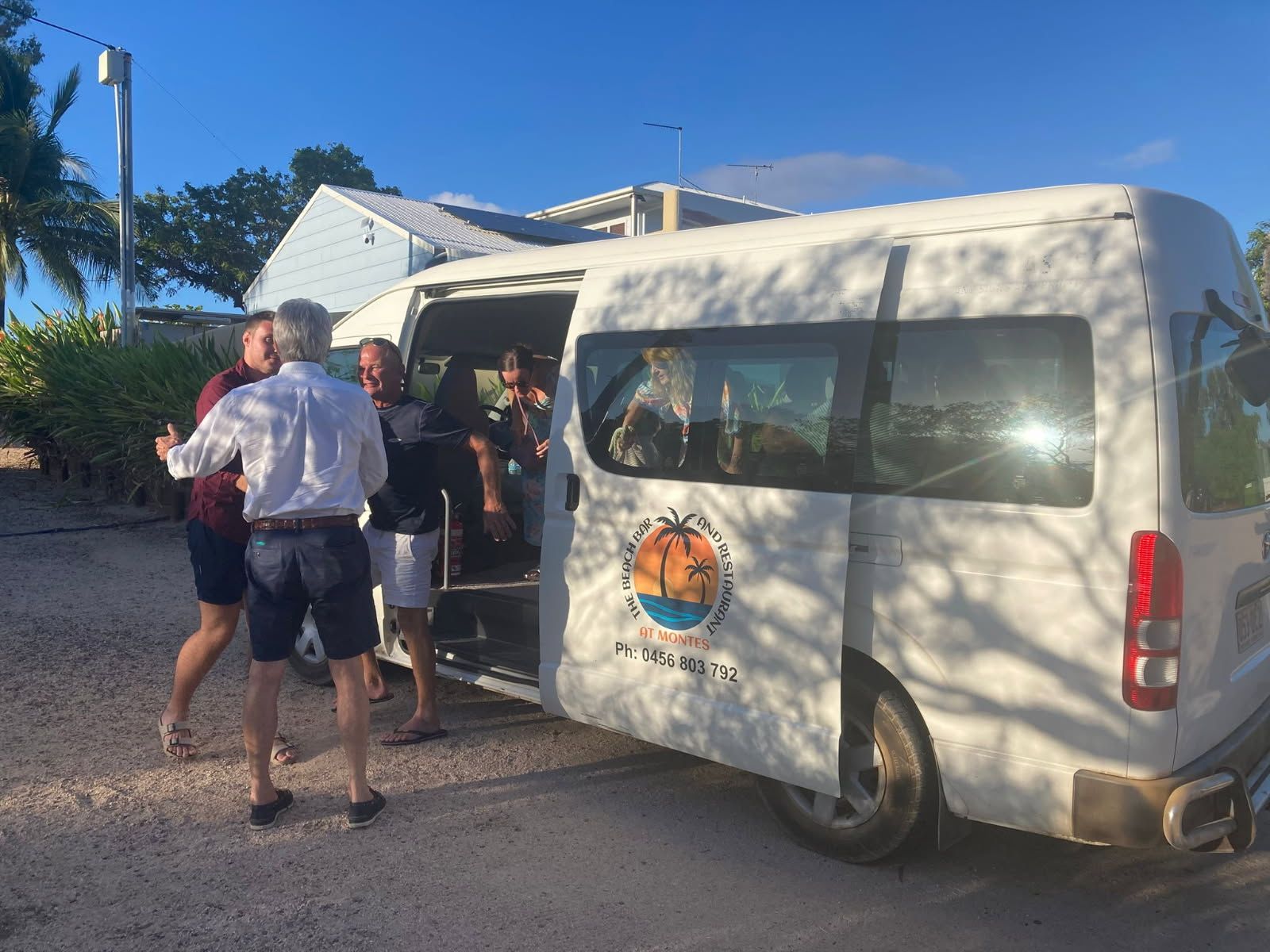 People Boarding a White Passenger Van With Logo — The Beach Bar and Restaurant at Montes in Cape Gloucester, QLD