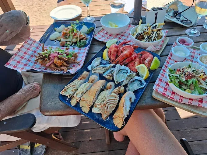 Seafood platter, prawns, and oysters on a wooden table — The Beach Bar and Restaurant at Montes in Cape Gloucester, QLD