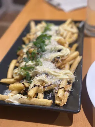 Fries with white sauce, grated cheese and green onions — The Beach Bar and Restaurant at Montes in Cape Gloucester, QLD