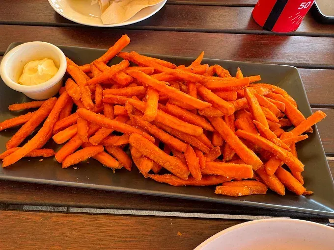 Sweet potato fries with a small cup of dipping sauce — The Beach Bar and Restaurant at Montes in Cape Gloucester, QLD