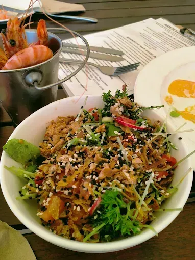 Salad with shrimp in a metal bucket and fried egg on a plate — The Beach Bar and Restaurant at Montes in Cape Gloucester, QLD
