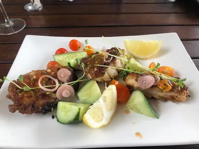 Fish with cucumber, tomato, shallots, and lemon — The Beach Bar and Restaurant at Montes in Cape Gloucester, QLD