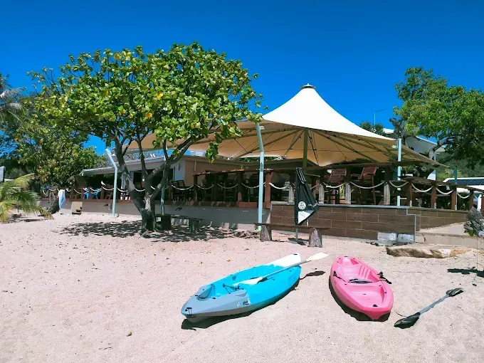 Beachfront restaurant with kayaks on the sand — The Beach Bar and Restaurant at Montes in Cape Gloucester, QLD