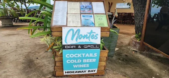 A sign for Montes Bar & Grill in Hideaway Bay — The Beach Bar and Restaurant at Montes in Cape Gloucester, QLD