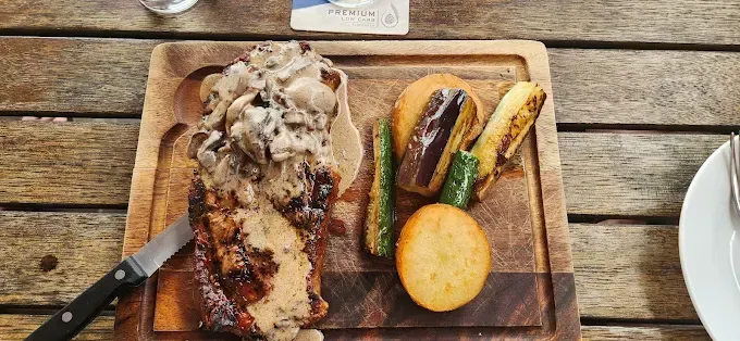 Steak with mushroom sauce, served with roasted vegetables — The Beach Bar and Restaurant at Montes in Cape Gloucester, QLD