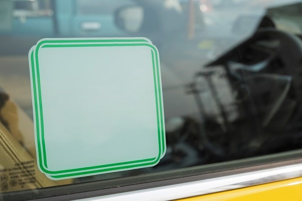 Square Sticker With a Green Border and a Blank Center on a Car Window — DXMA Designs In Bargo, NSW