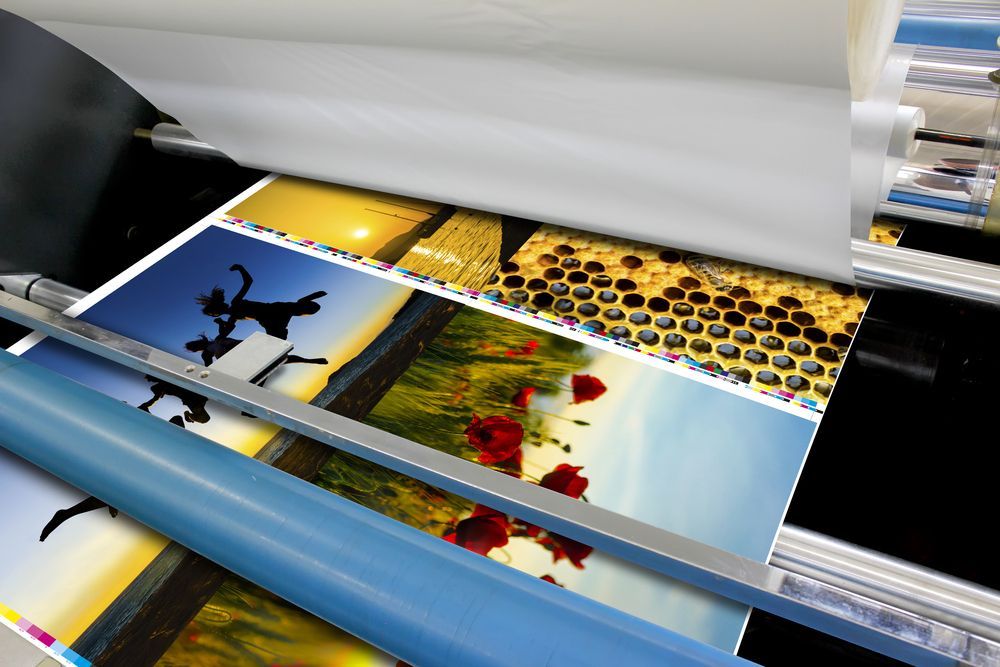 Printing Press Laminating Colourful Prints — DXMA Designs In Bargo, NSW