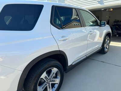 White SUV parked on a driveway.